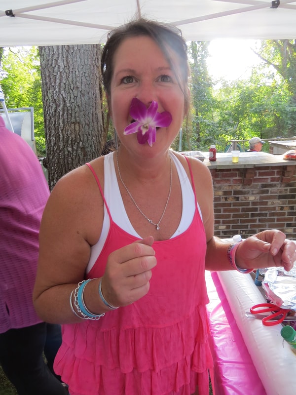 Attendee having fun with a flower at Boobstock