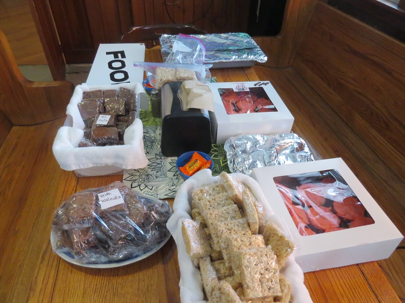 Baked goods table with brownies, rice crispy treats, and more at Boobstock