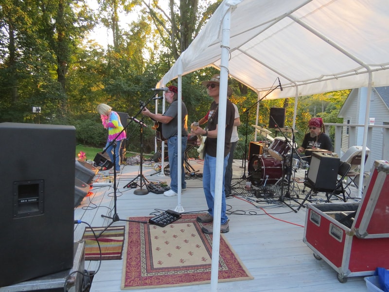 Live band performing on stage at Boobstock